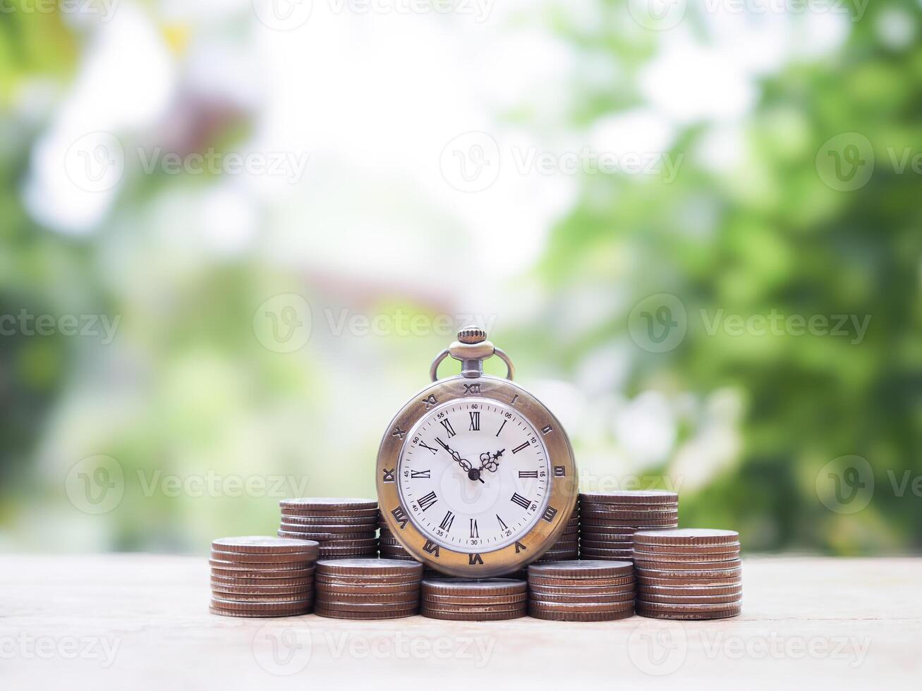 Vintage watch on stack of coins. The concept of saving money for manage time to success business. photo