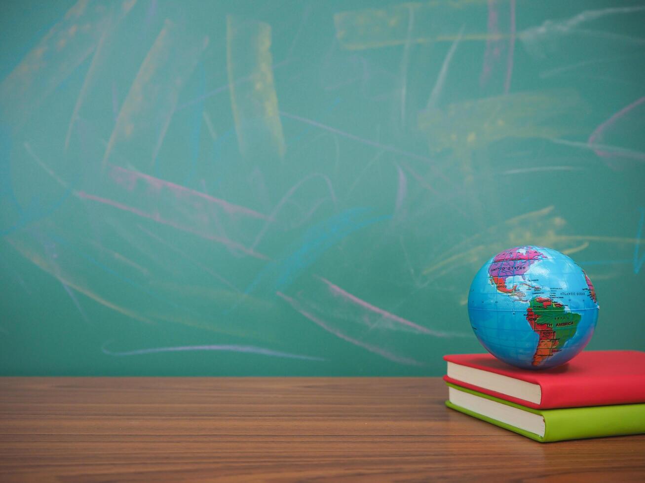 Student creative desktop with earth globe on hardcover book. Copy space for text, Back to school, Education concept photo