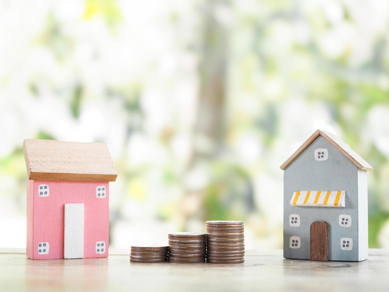 Miniature house and stack of coins. The concept of saving money for house, Property investment, House mortgage, Real estate photo