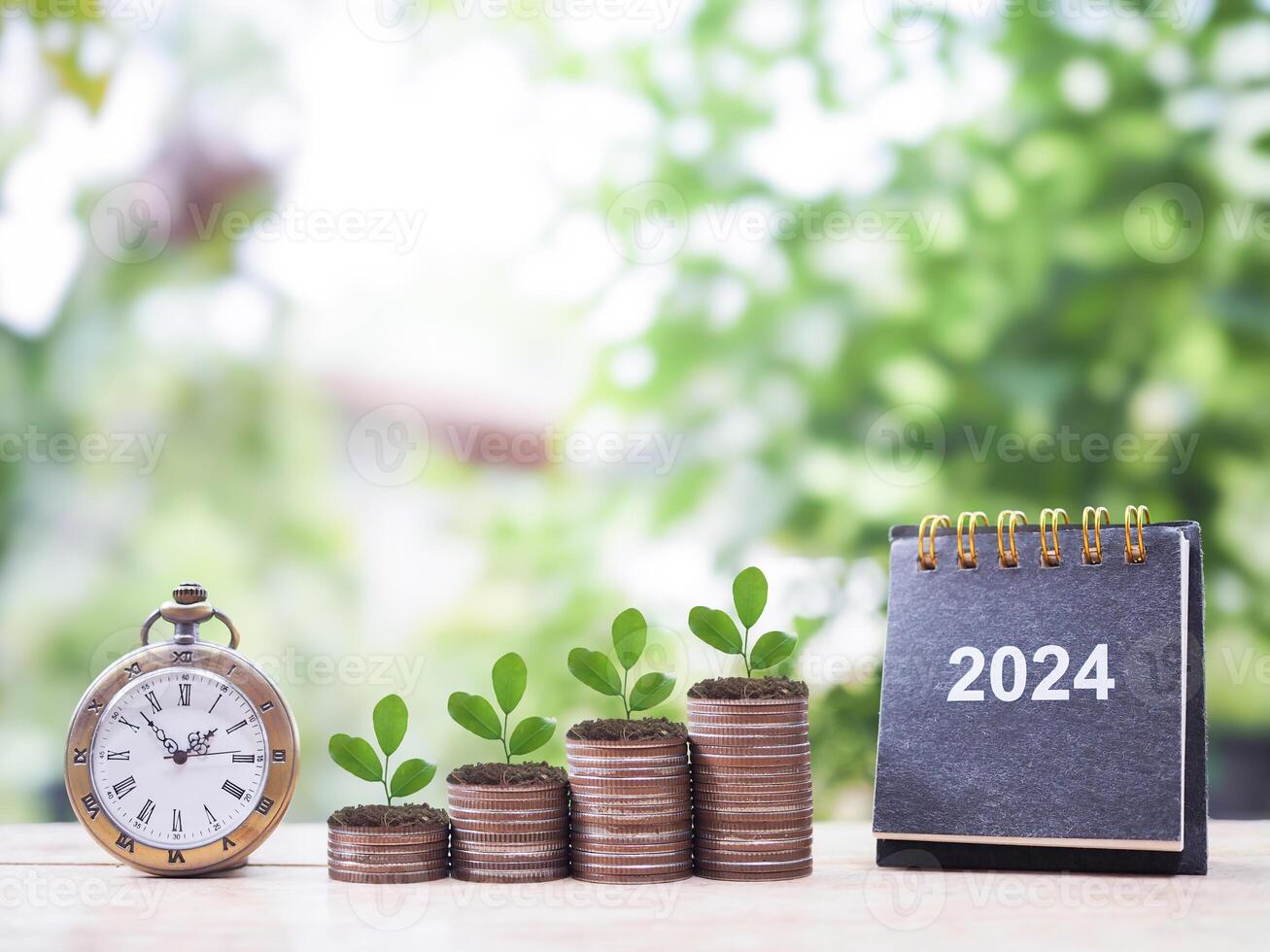Vintage watch, 2024 desk calendar and Plants growing up on stack of coins. The concept of saving money, Financial, Investment and Business growing in year 2024. photo