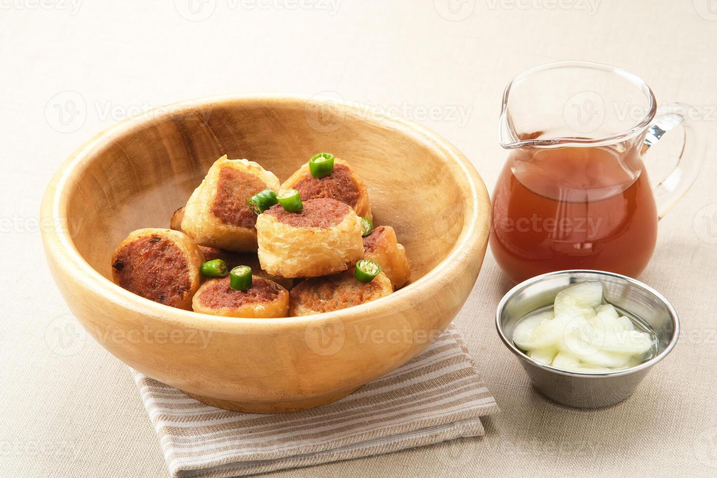 Gohyong or Ngo Hiang, made from minced chicken with flour, served with sour sauce photo