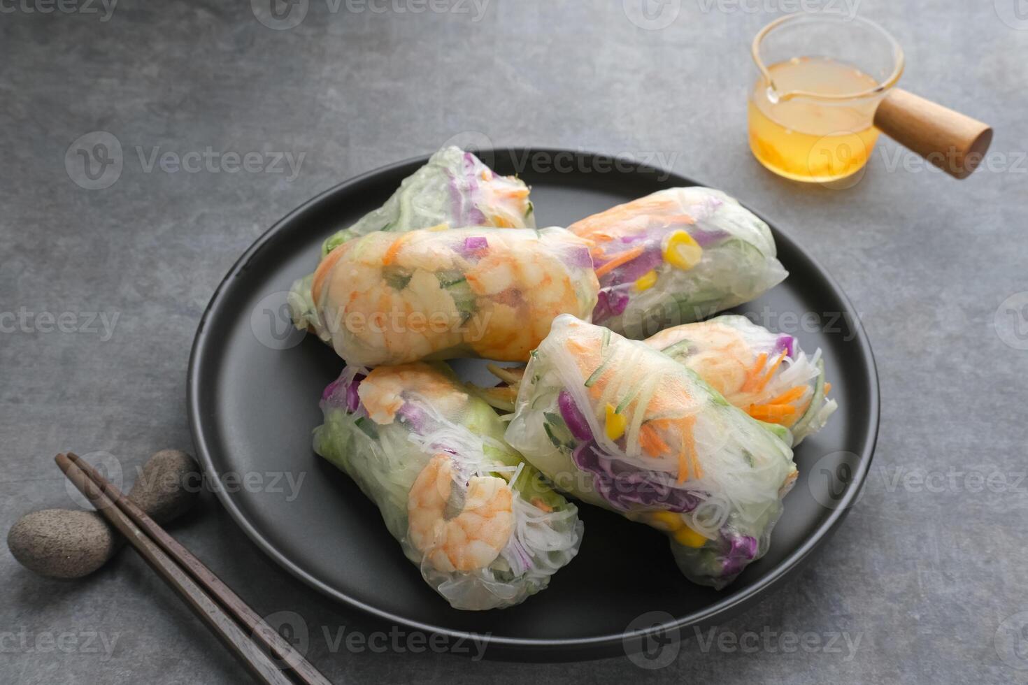 Vegetable spring roll, fresh roll salad made from mix vegetables with shrimp. Served in plate with caesar sauce dressing photo