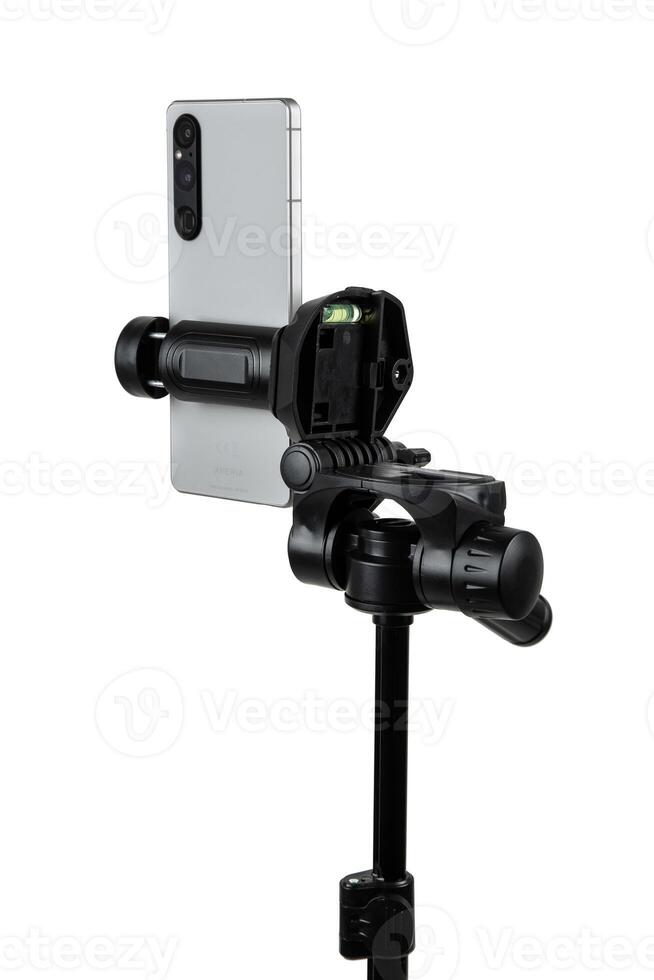 Smartphone mounted on a tripod. Stable photo or shooting for a blog or social media content. Isolate on a white back.