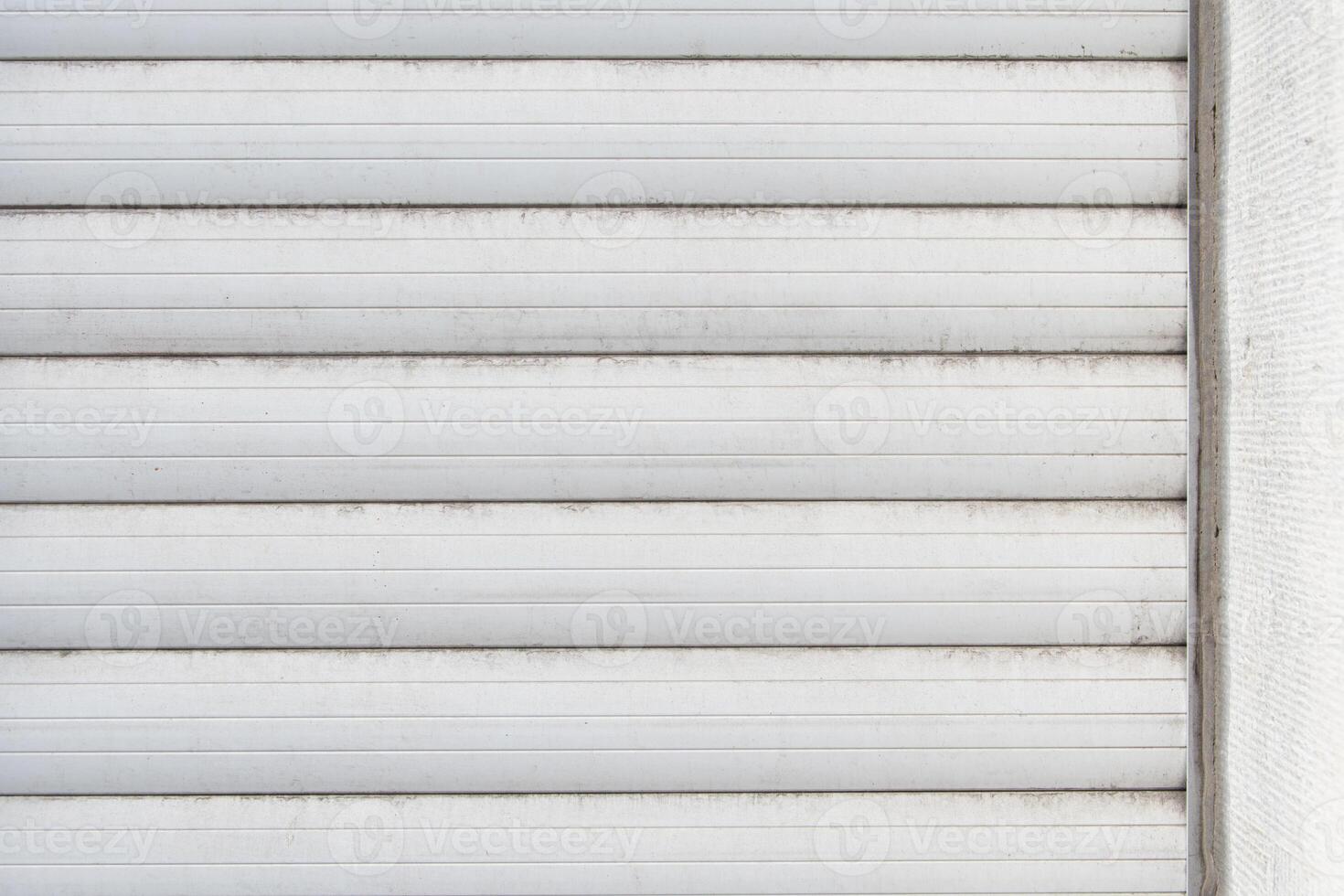 old white external blinds on hard plastic windows. fragment of adhesion to the wall photo