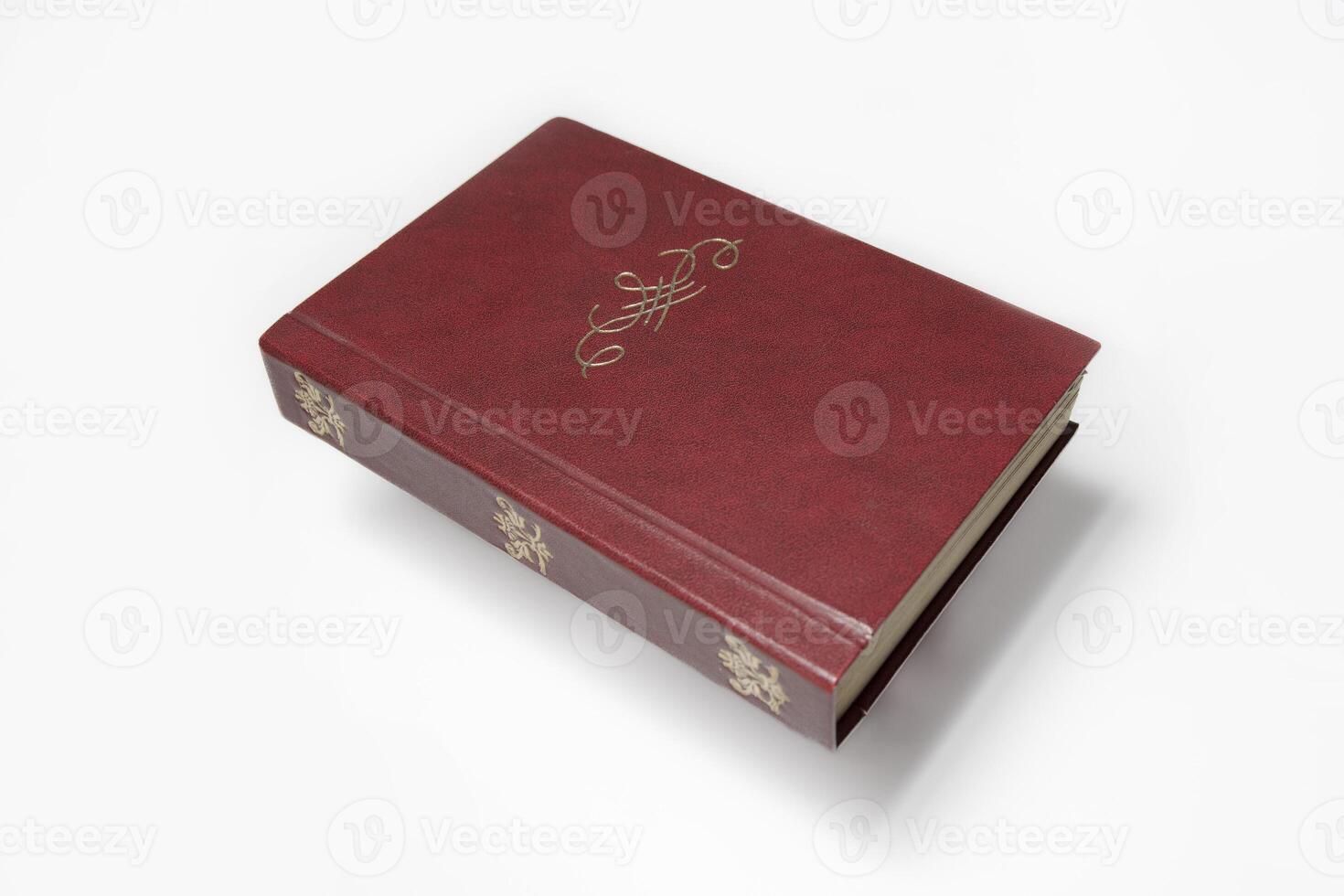 An untitled old book with an antique stylized monogram and free space for a title and text. On a white background with a deep hovering shadow photo