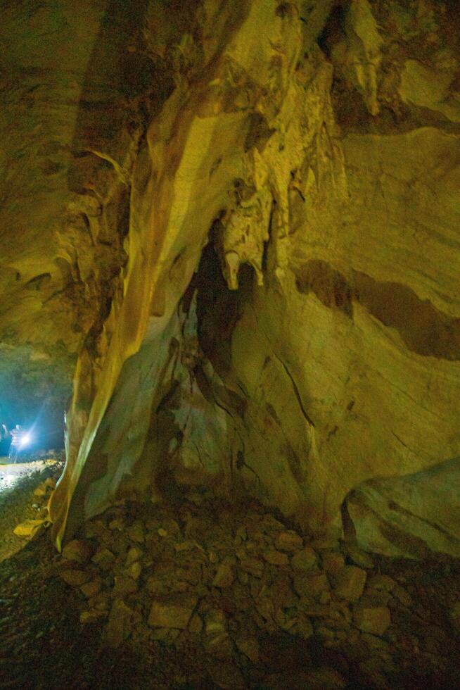The beautiful views of the stalactite and stalagmite-filled cave in National Park, Thailand. photo