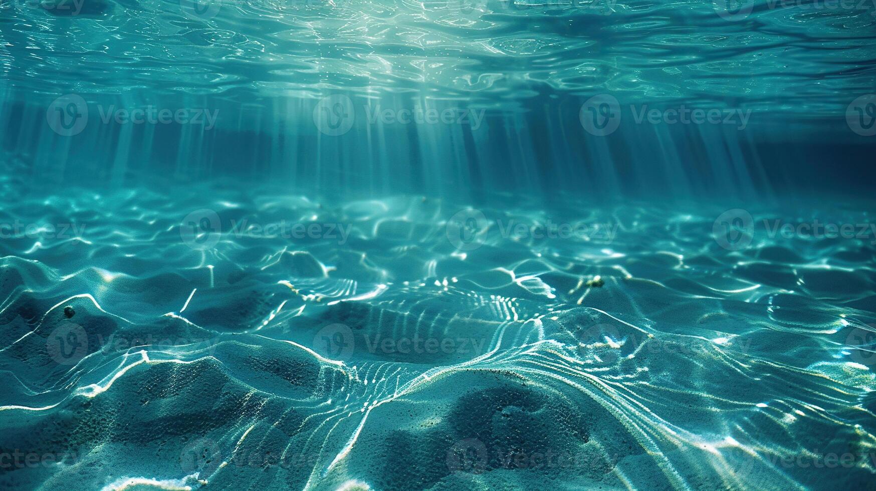 The sun's rays underwater illuminate the seabed. Underwater background with sun rays. Blue ocean or sea depth blue background. photo