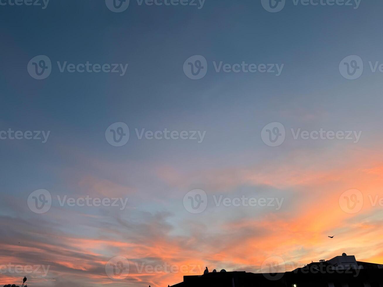 Sunset sky background concept. Twilight sky. Colorful skyline evening sunset in the city. photo