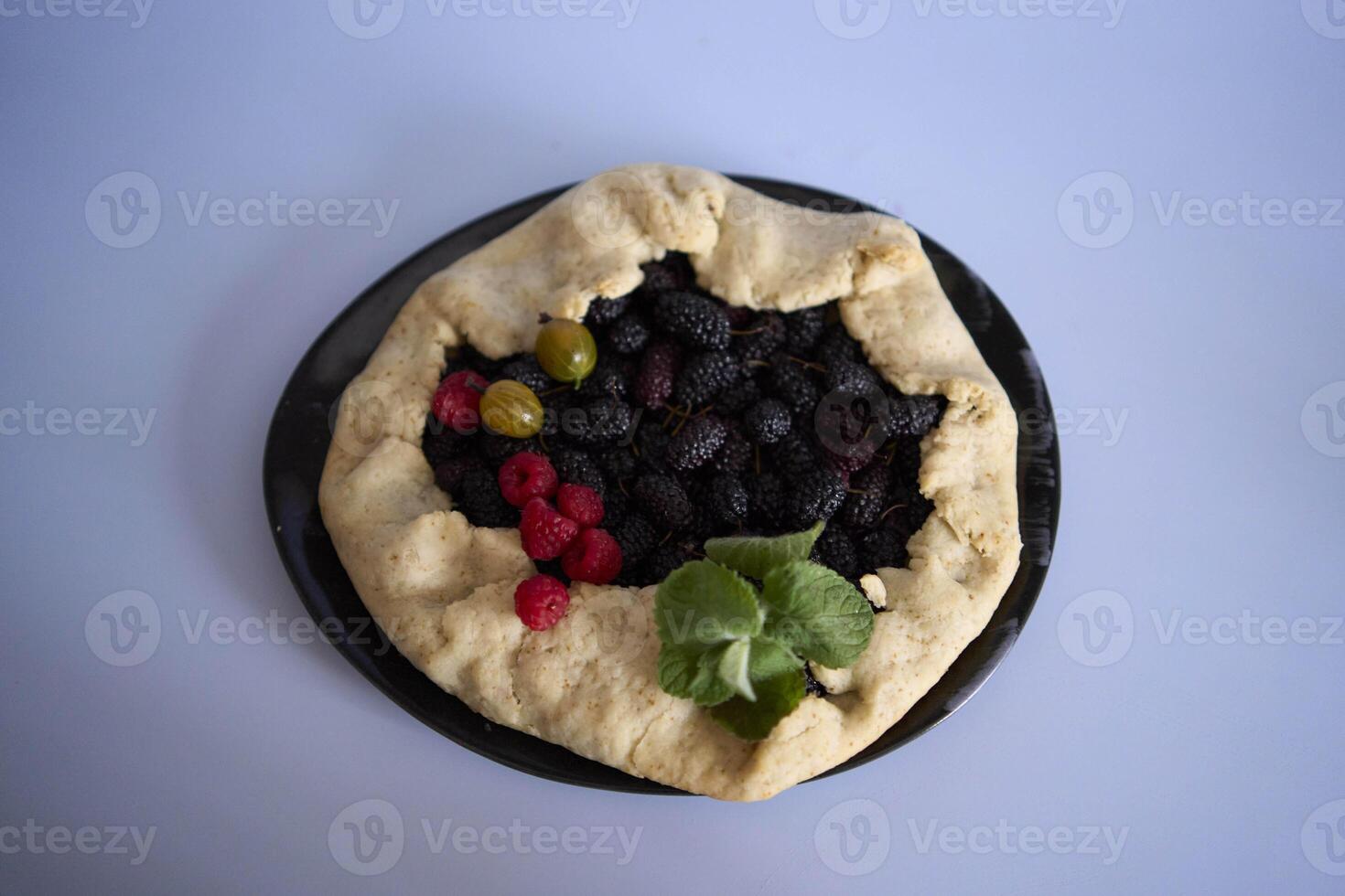 the process of making galette pie with mulberry photo