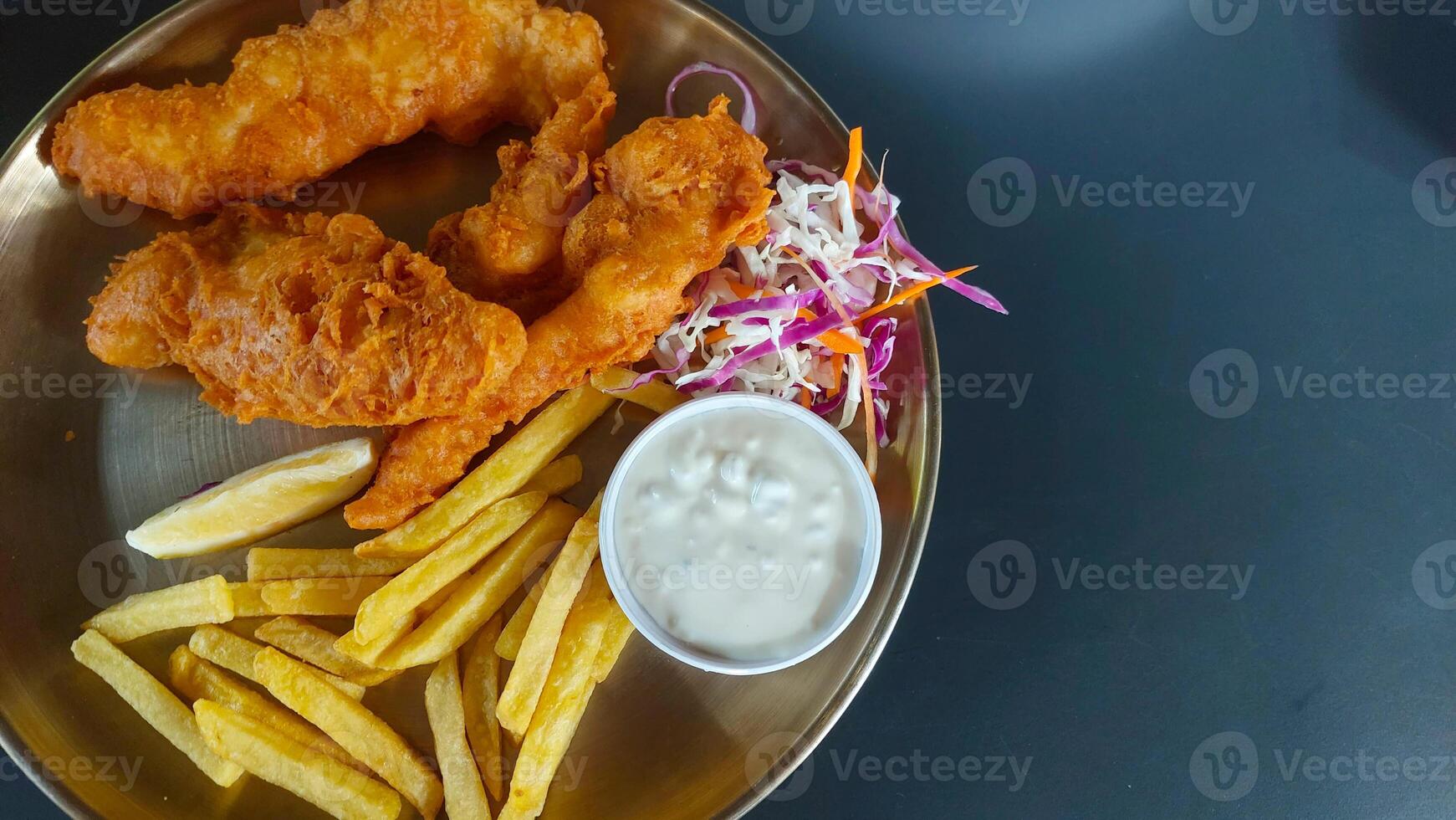 Chicken Fried schnitzel with fries on golden plate with sauce photo