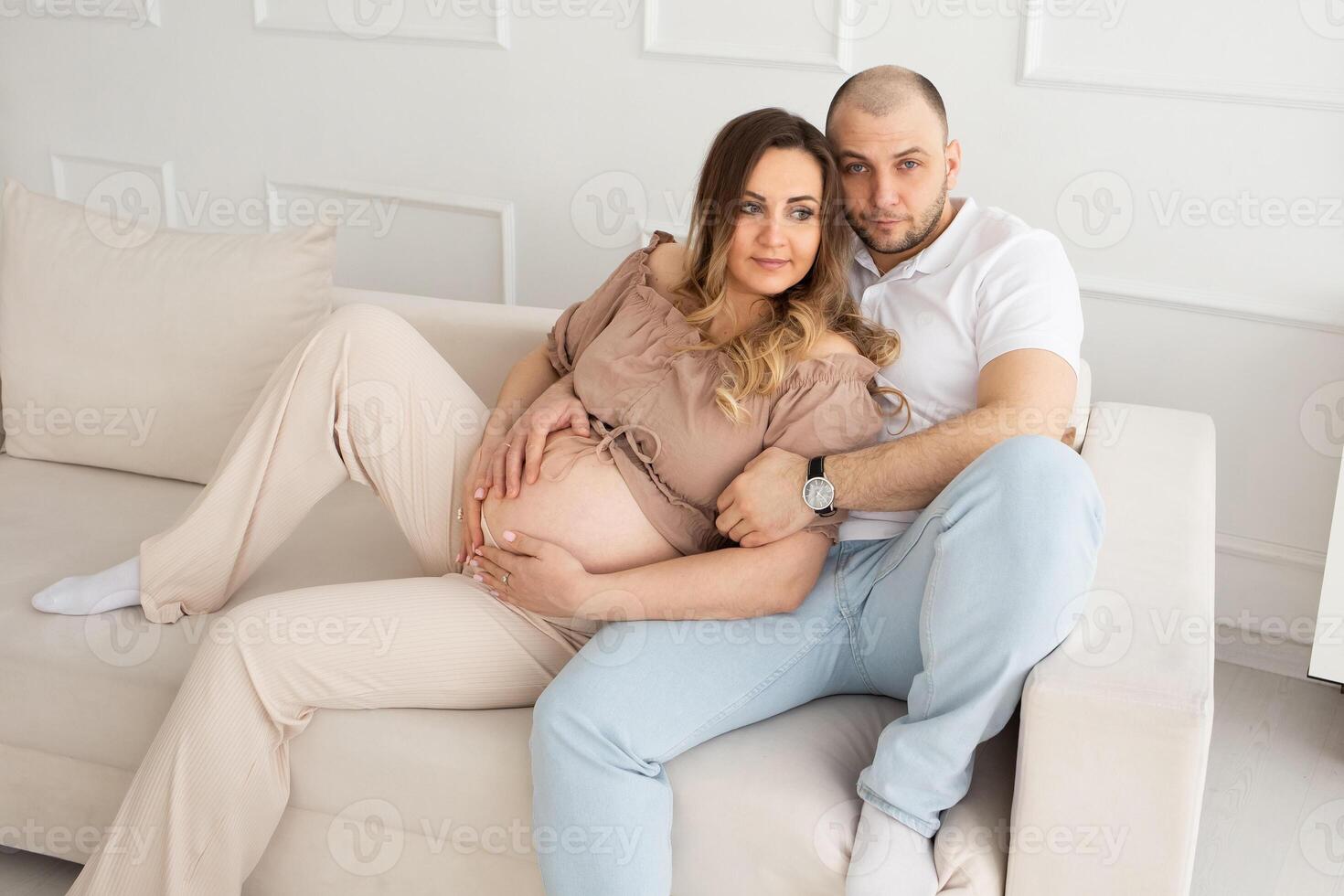 family concept. happiness concept. close-up portrait of a pregnant belly that embraces female and male hands. close-up portrait of embracing spouses photo