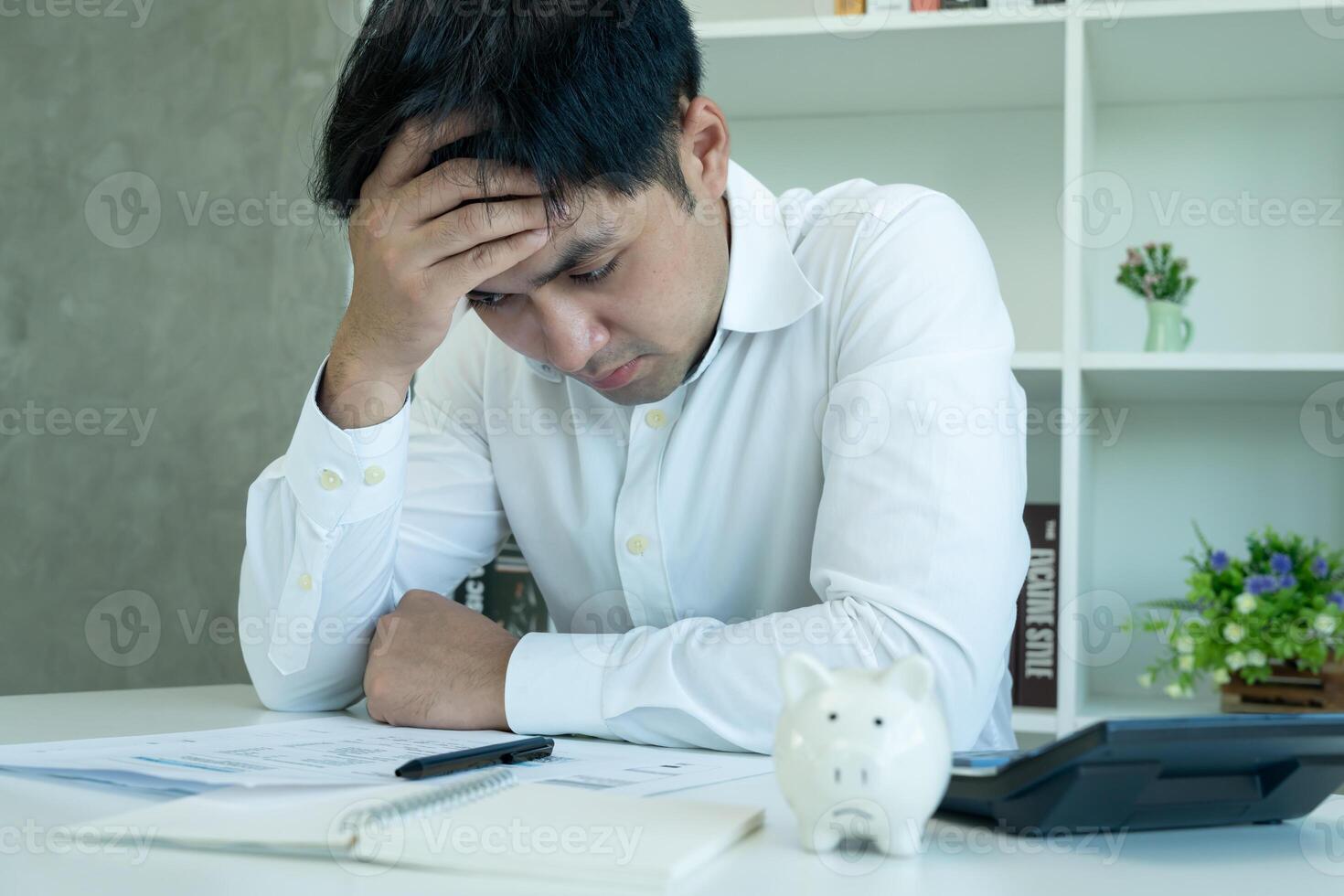 Stressed and headache asian man with large bills or invoices no money to pay to expenses and credit card debt. shortage, Financial problems, mortgage, loan, bankruptcy, bankrupt, poor, empty wallet photo