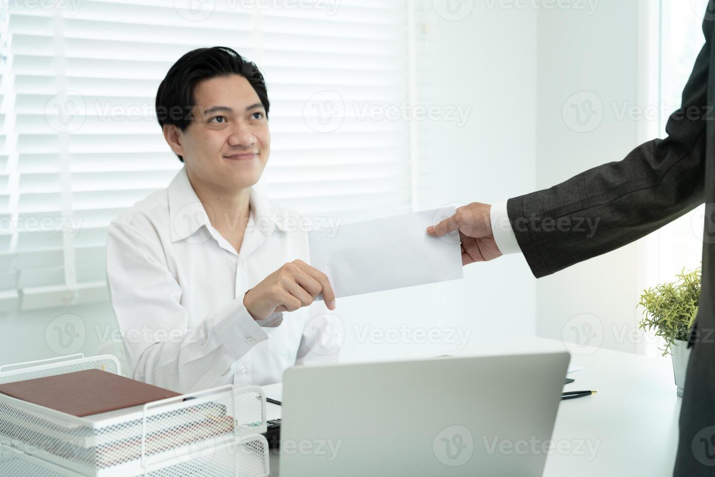 Businessmen receive salary or bonuses from management or Boss. Company give rewards to encourage work. Smiling businessman enjoying a reward at the desk in the office. photo