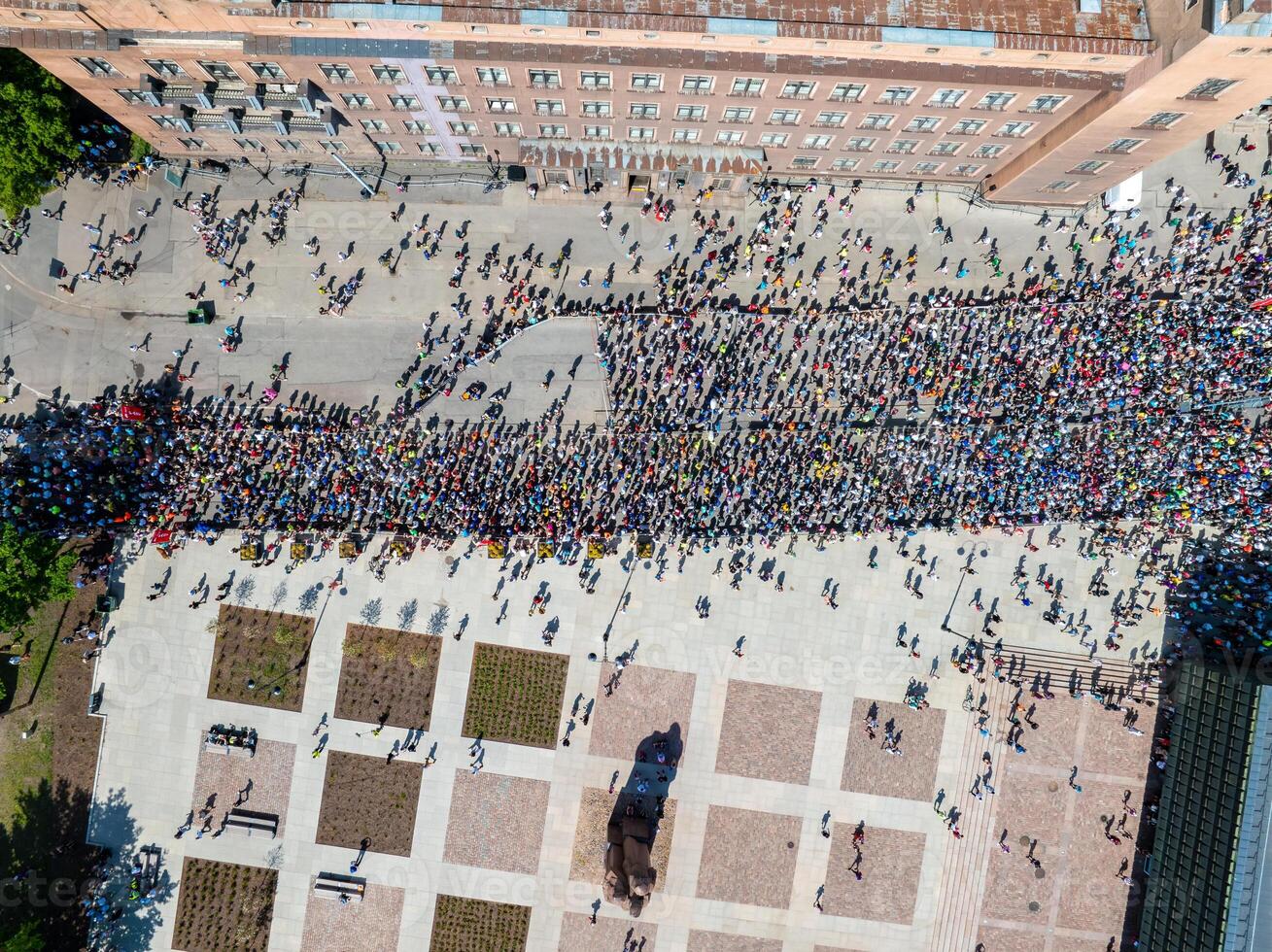 Aerial View of a Vibrant Crowd in Riga City Square Surrounded by Buildings photo