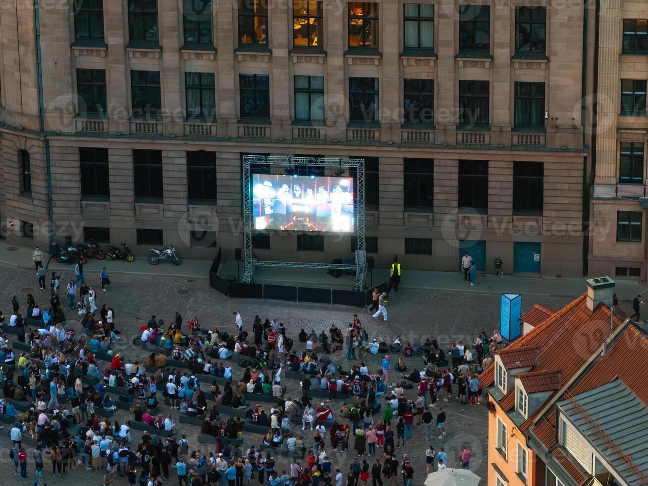 Aerial View of Crowd Watching Live Event on Large Screen in City Center photo