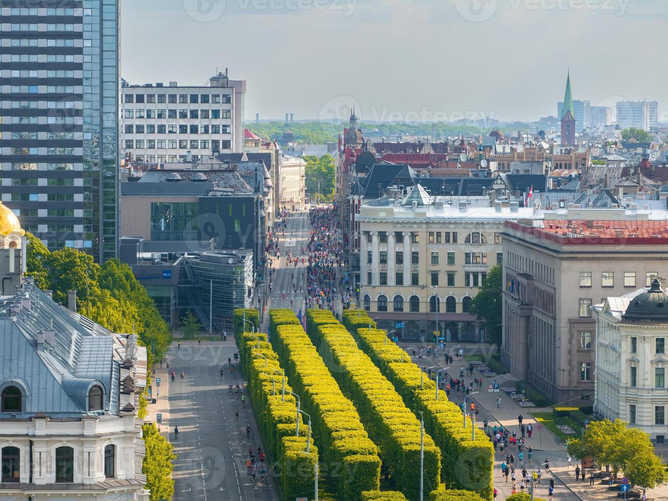 Aerial View of Marathon Runners in Riga, Latvia, Surrounded by Cityscape photo