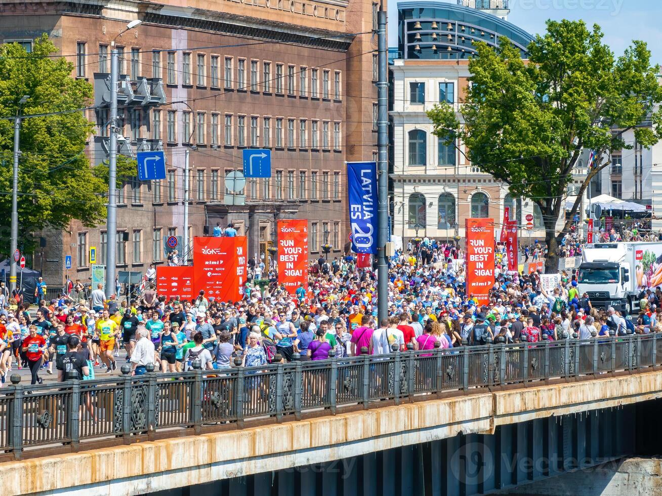 Runners Participating in Riga Rimi Marathon 2024 on a Bridge in Riga, Latvia photo