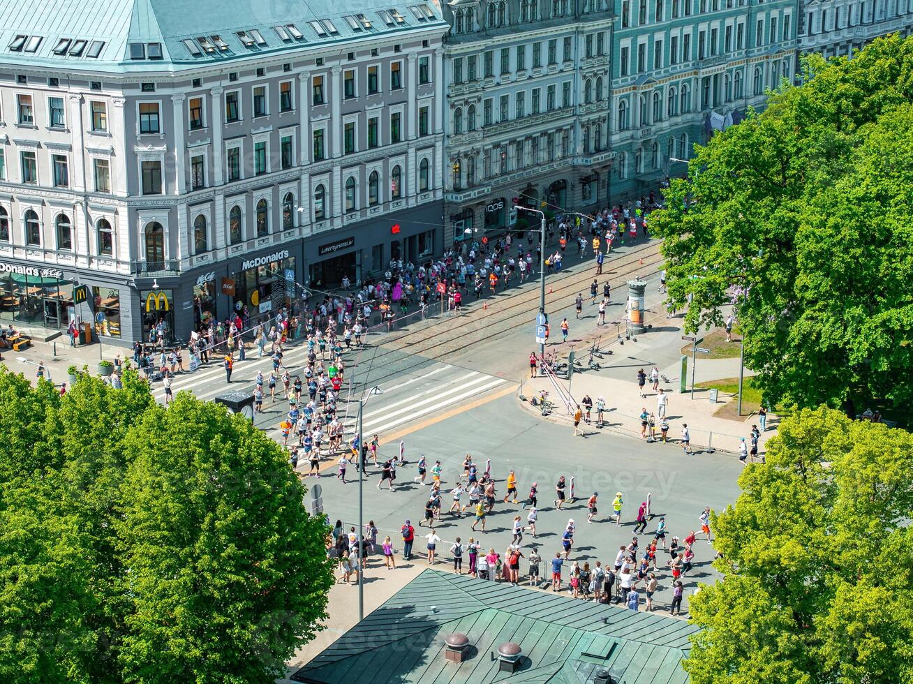 Aerial View of Marathon Runners Navigating Riga's City Streets in Latvia photo