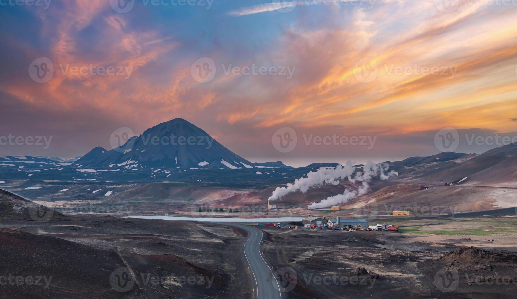 Scenic Volcanic Landscape with Snow-Capped Volcano and Winding Road in Iceland photo