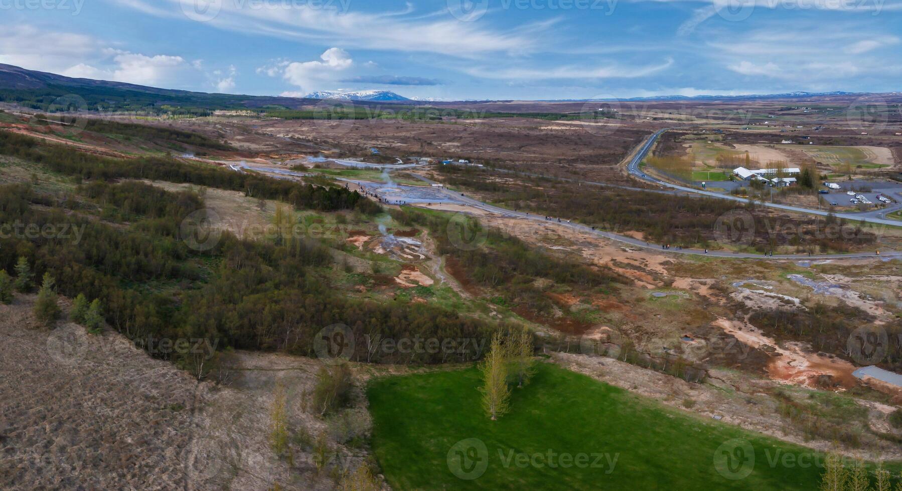 Aerial View of Winding Road Through Verdant Valley in Iceland photo