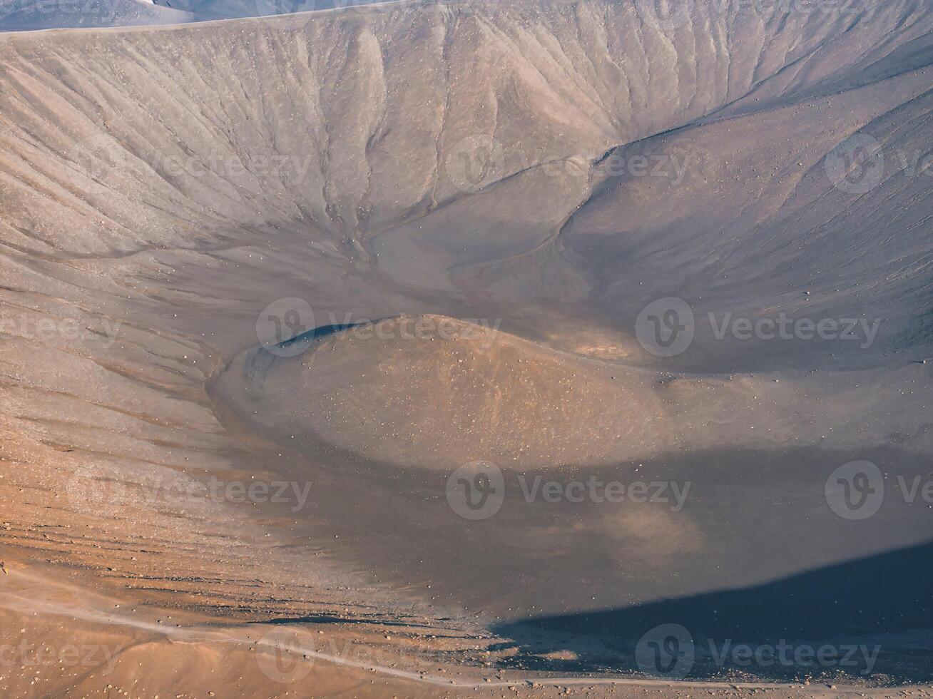 Aerial View of a Volcanic Crater with Rocky Rim in Iceland's Barren Landscape photo