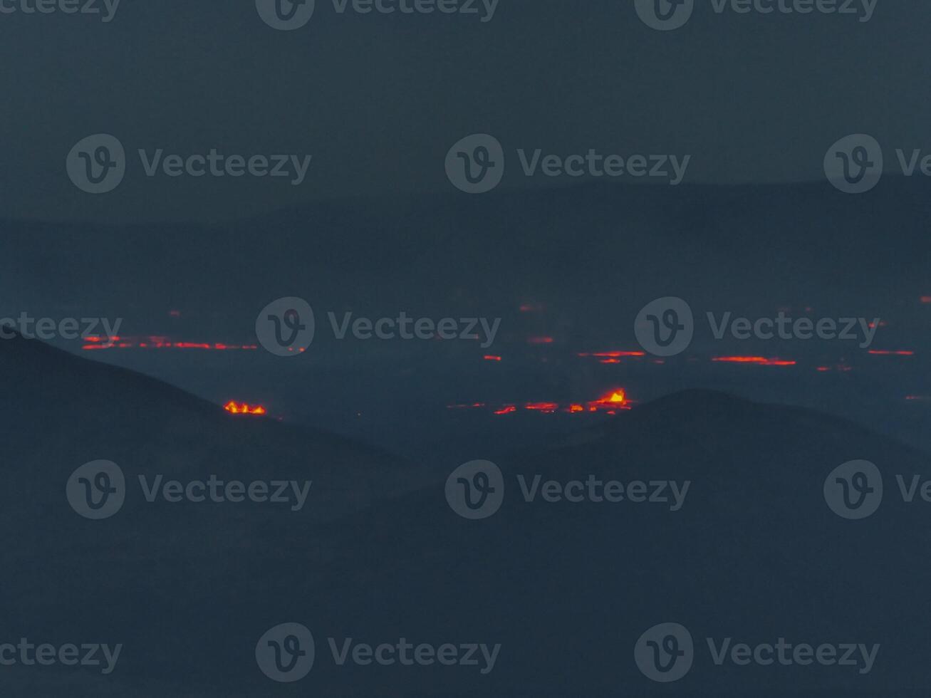Aerial View of Volcanic Eruption with Red Lava Flows in Iceland photo