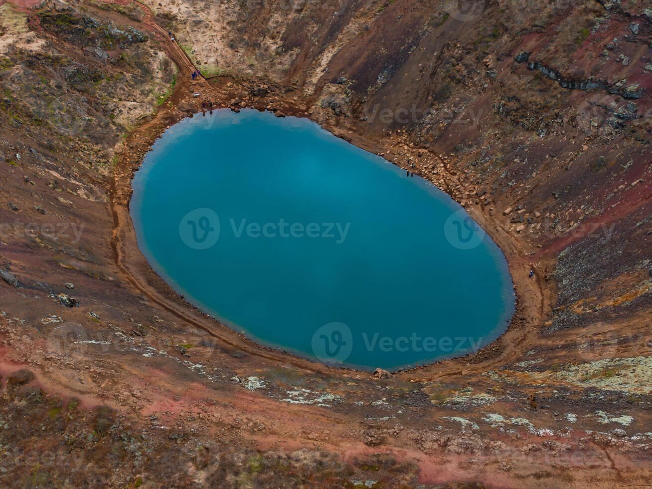 Aerial View of Vibrant Blue Volcanic Crater Lake in Iceland's Scenic Landscape photo
