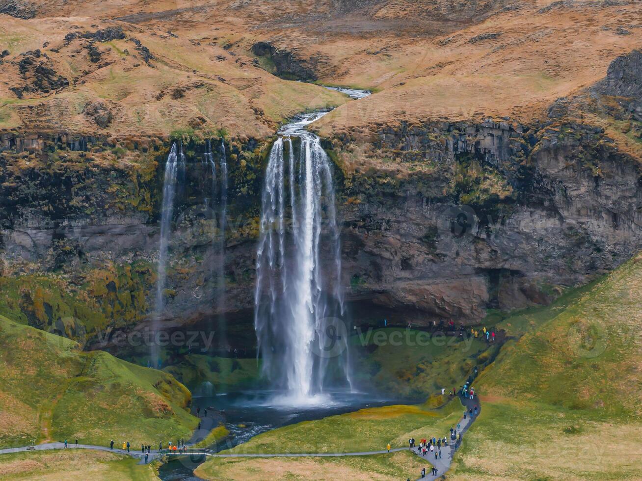 Aerial View of Seljalandsfoss Waterfall Cascading Down a Cliff in Iceland photo
