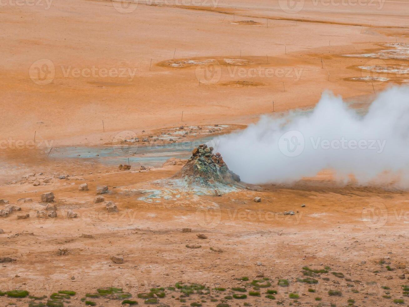 Aerial View of Geyser Erupting in Iceland's Geothermal Landscape photo