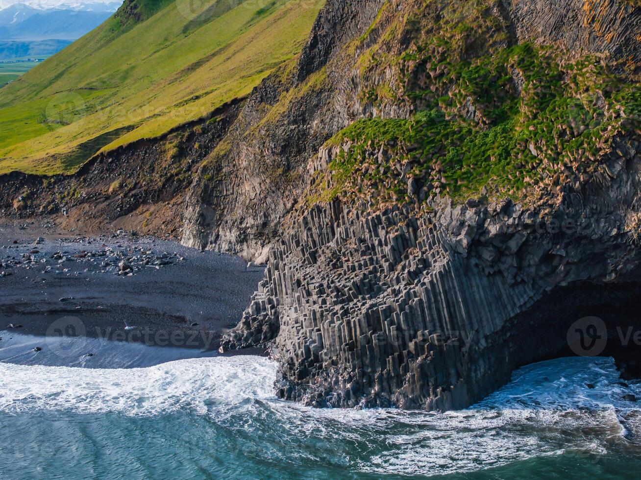 Aerial View of Black Sand Beach with Basalt Columns in Iceland photo
