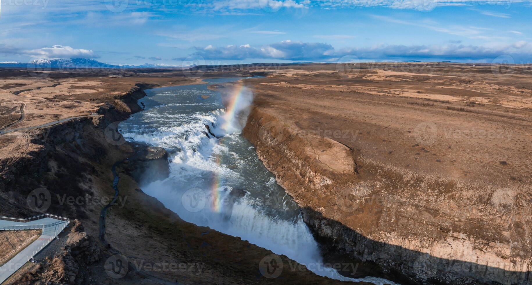 Aerial View of Gullfoss Waterfall with Rainbow in Iceland's Rocky Landscape photo
