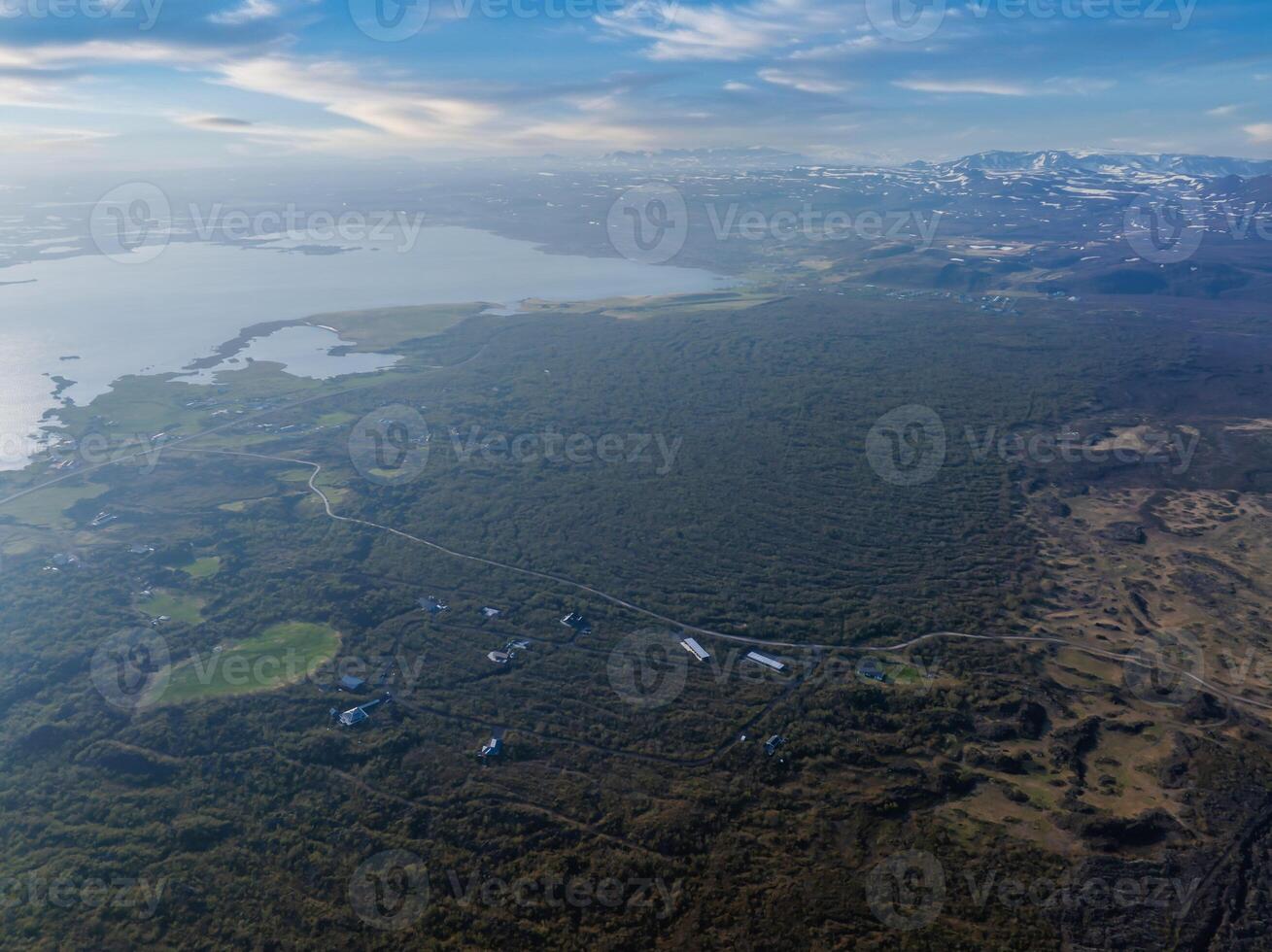 Aerial View of Icelandic Landscape with Winding Road and Distant Water photo