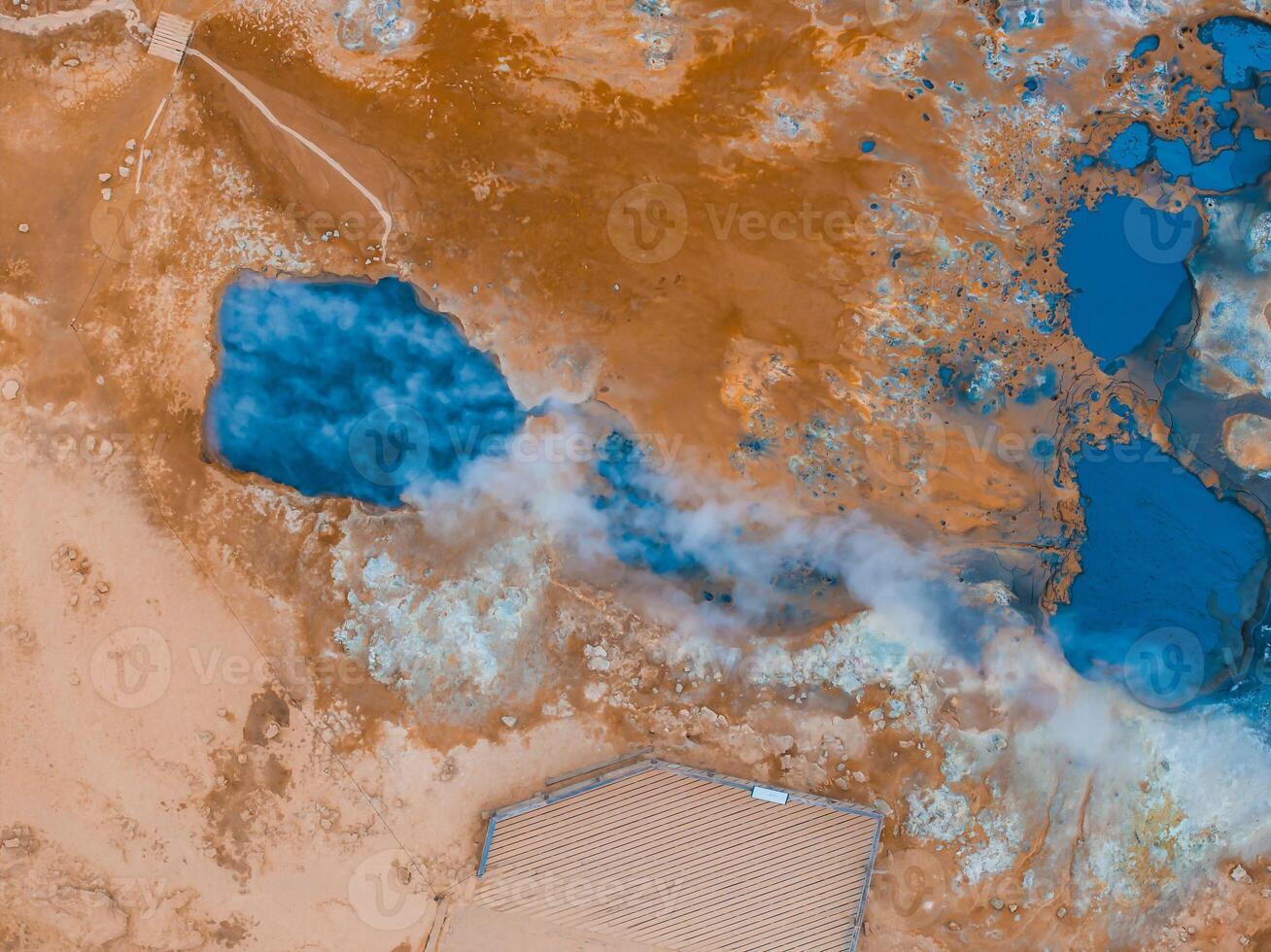 Aerial View of Steaming Blue Geothermal Pool in Iceland's Unique Landscape photo