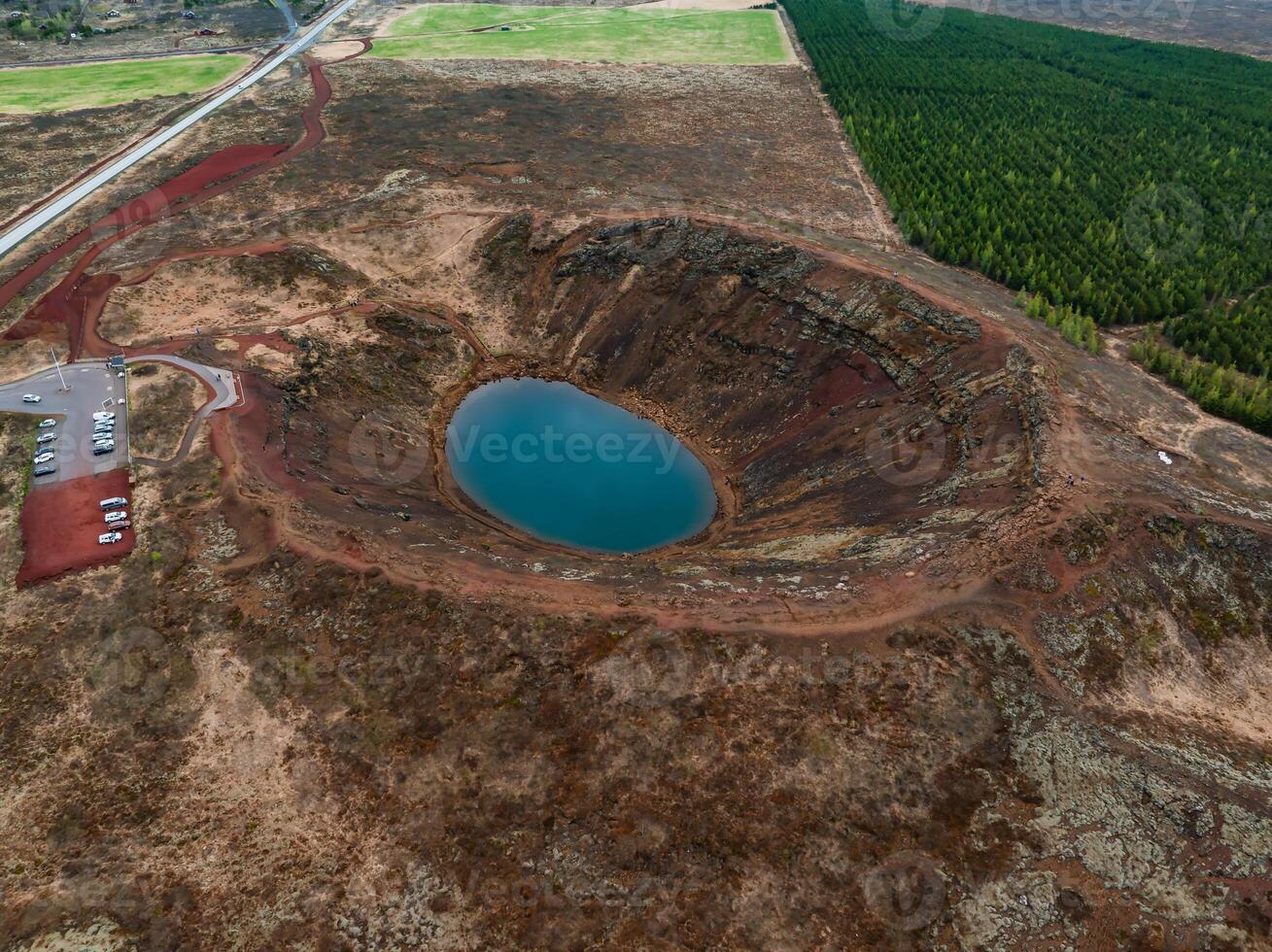 Aerial View of Volcanic Crater Lake with Bright Blue Water in Iceland photo