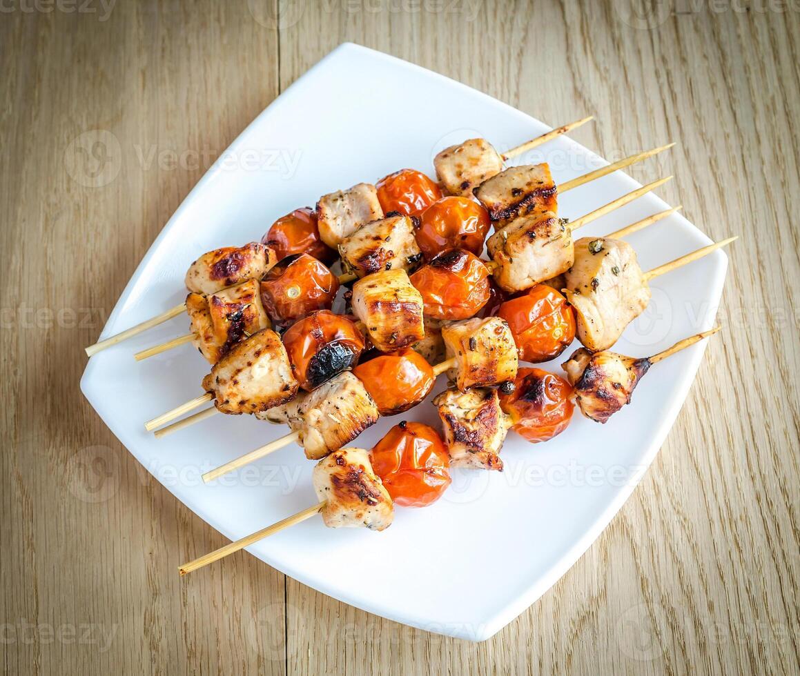 Grilled chicken skewers with cherry tomatoes photo