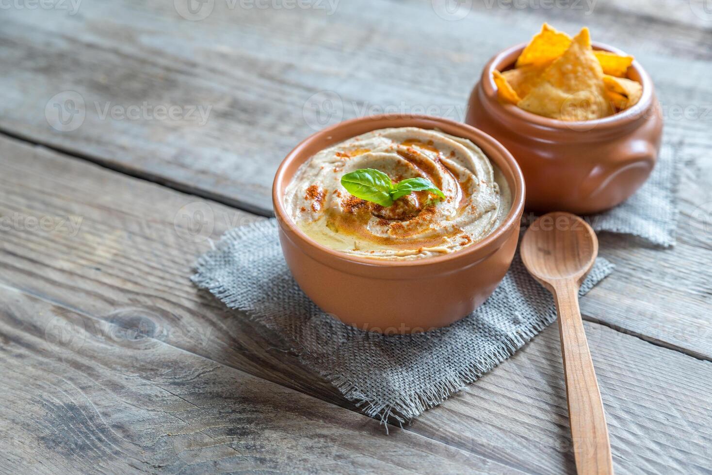 A bowl of hummus with corn chips photo