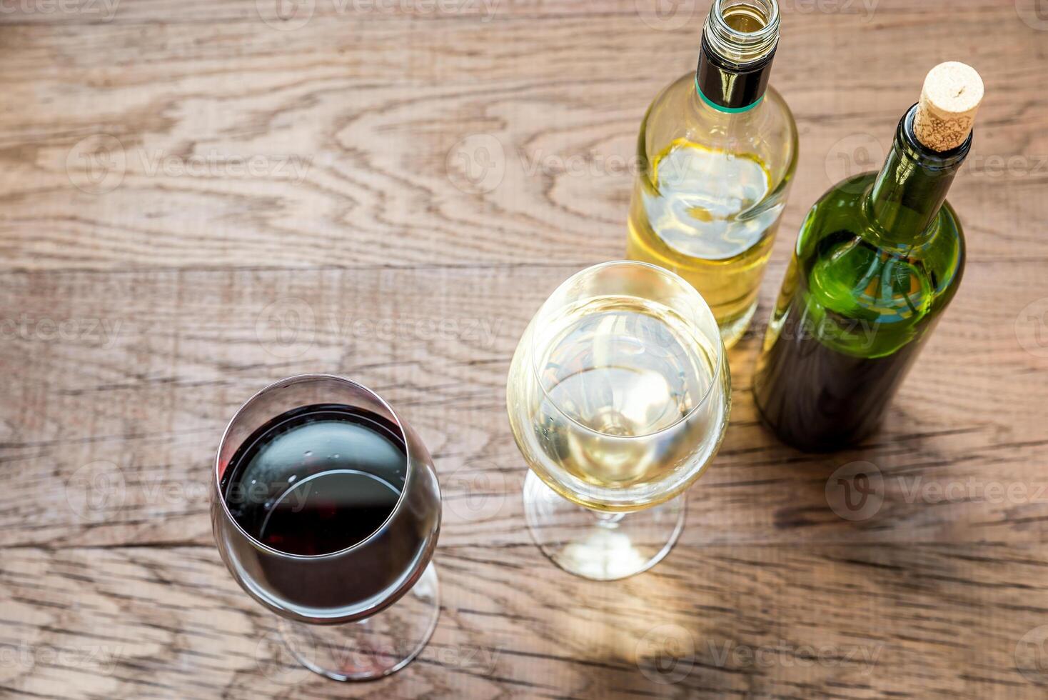 Glasses and bottles with red and white wine photo