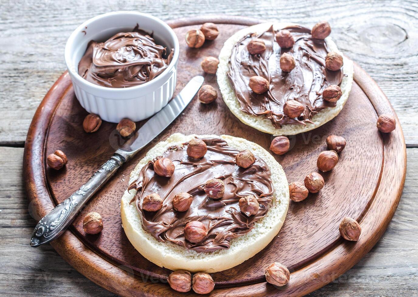 Bun slices with chocolate cream and nuts photo