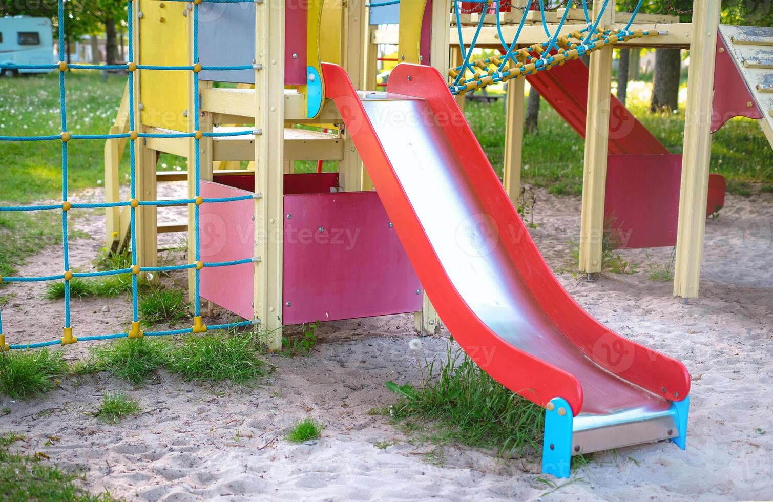 Children's playground with a red slide, perfect for outdoor recreation photo