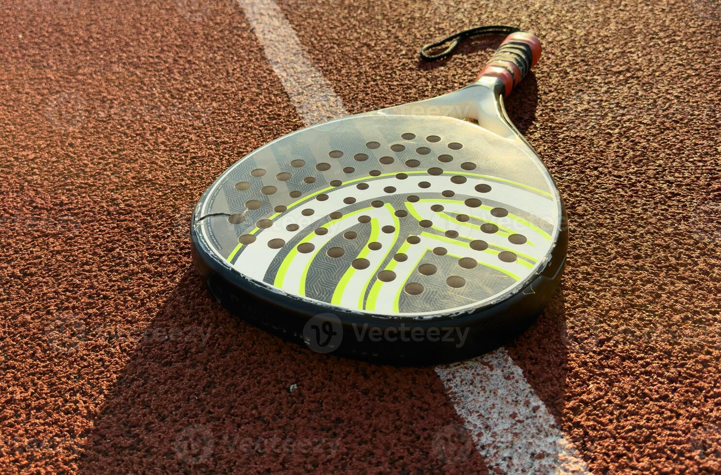 professional paddle tennis racket with natural lighting on court background. Horizontal sport theme poster, greeting cards, headers, website and app photo