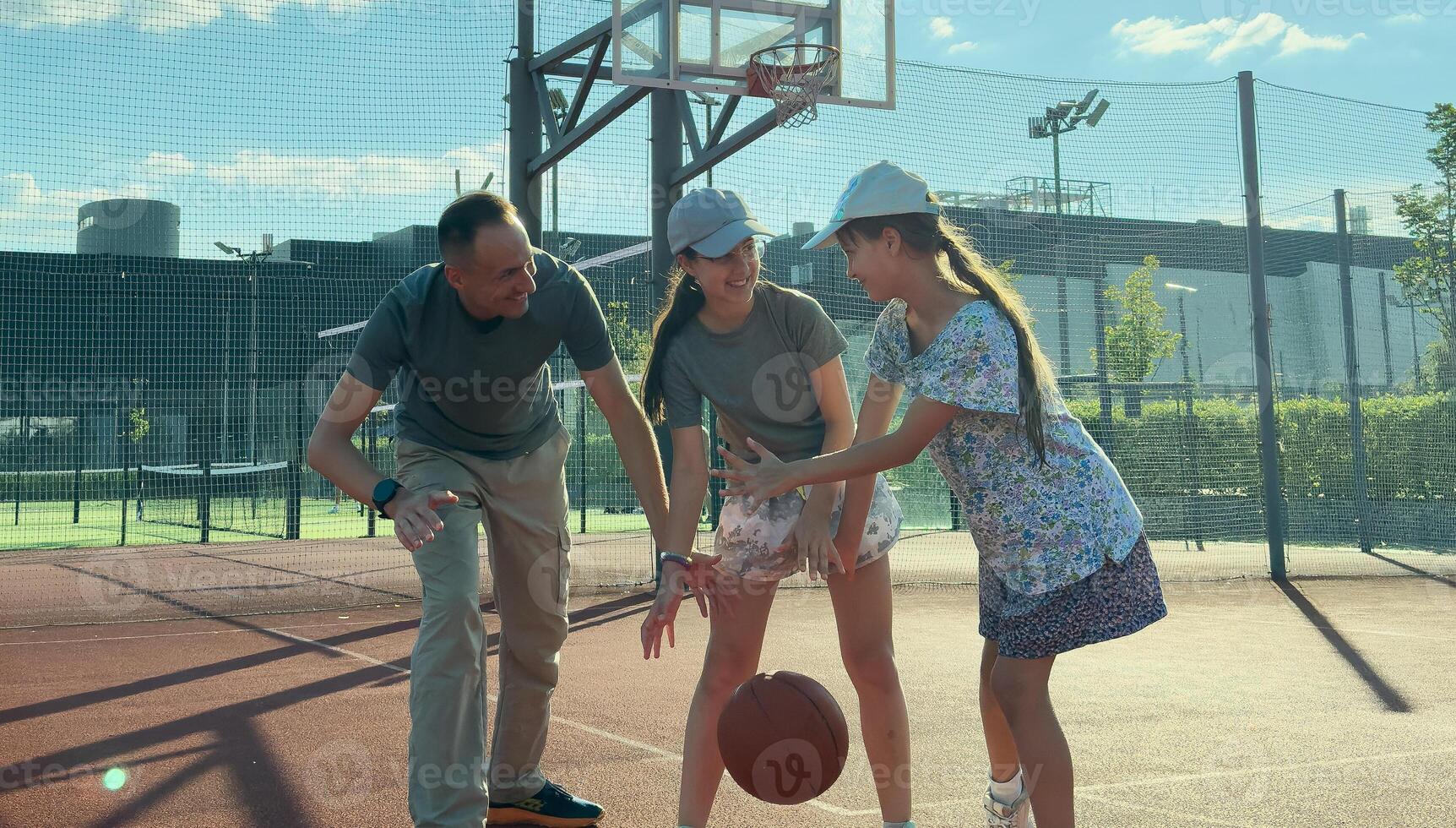 Basketball trainer showing how to shoot basketball to a child . Coach training a kid. photo