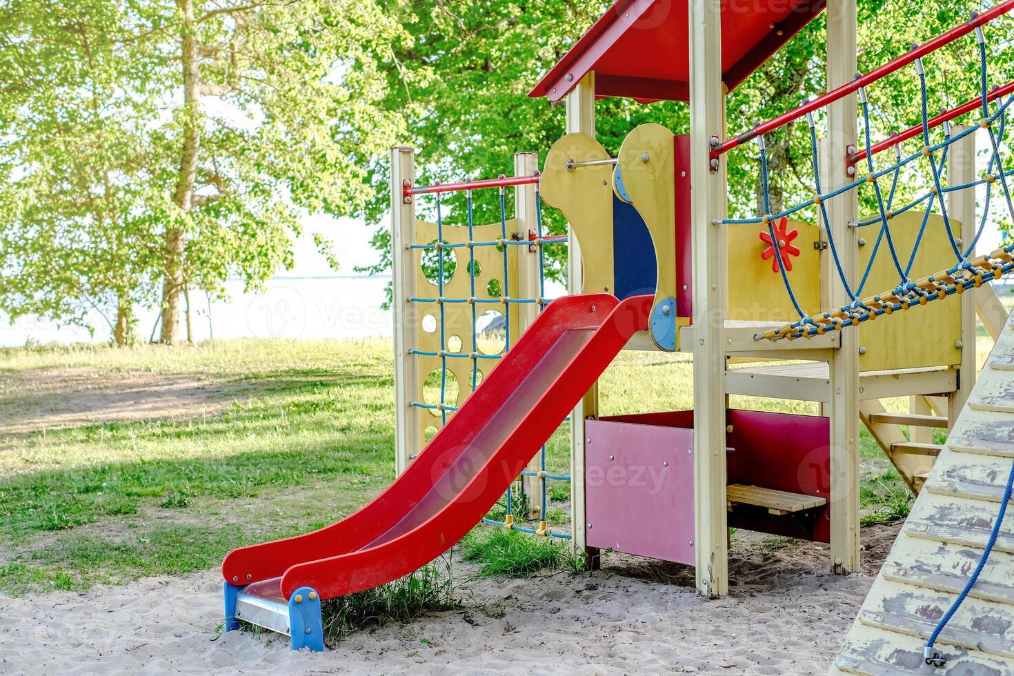 Children's playground with a red slide, perfect for outdoor recreation photo