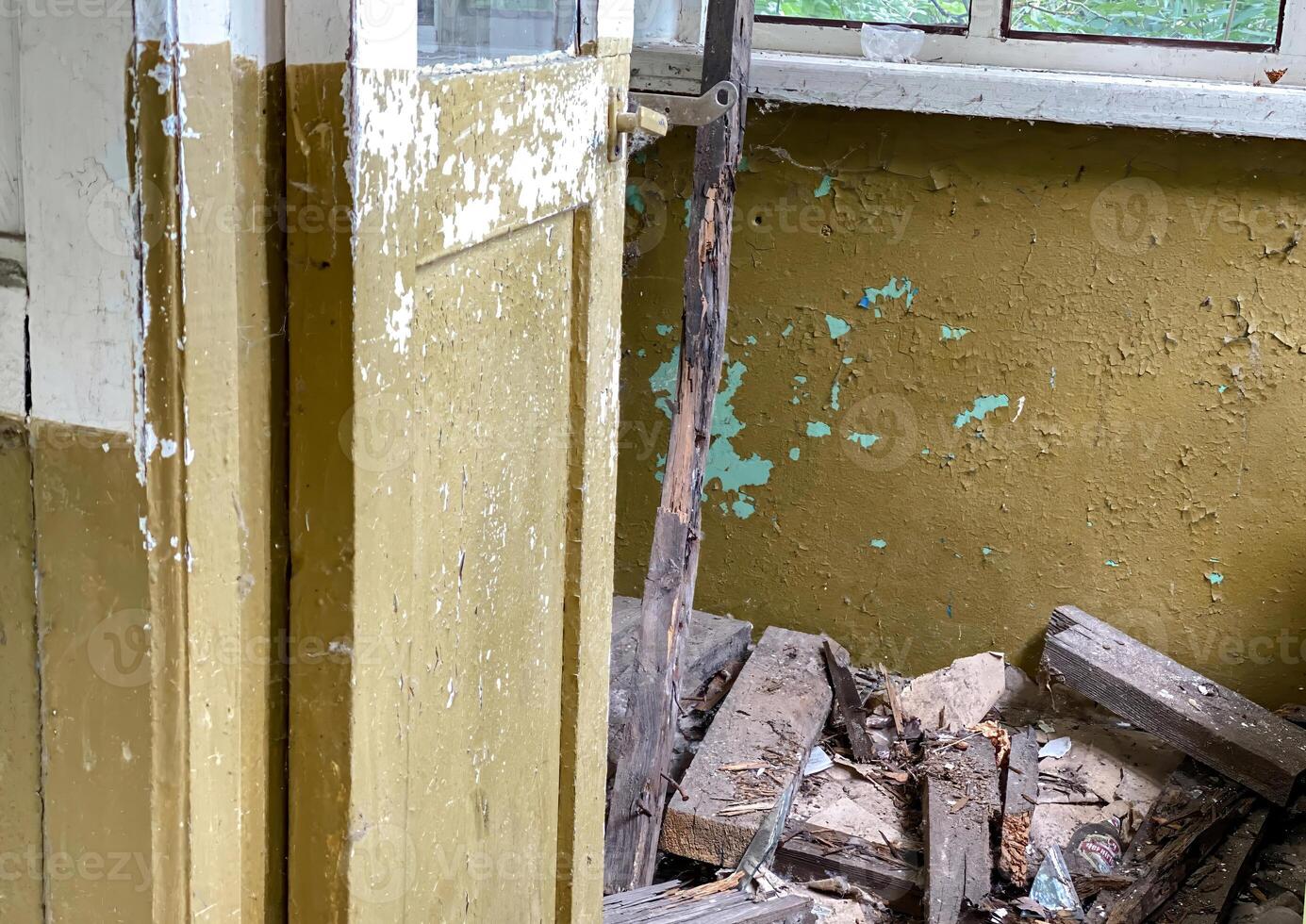 Abandoned blue door with chipped paint and a worn metal handle photo