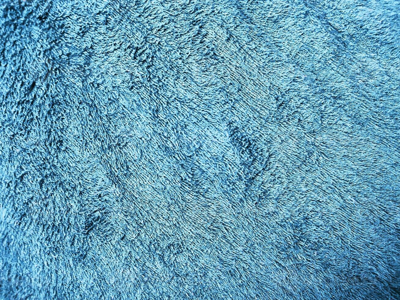 Blue background of towel texture. Beautifully folded white towels. Macro photo of beach towel. Soft textile background