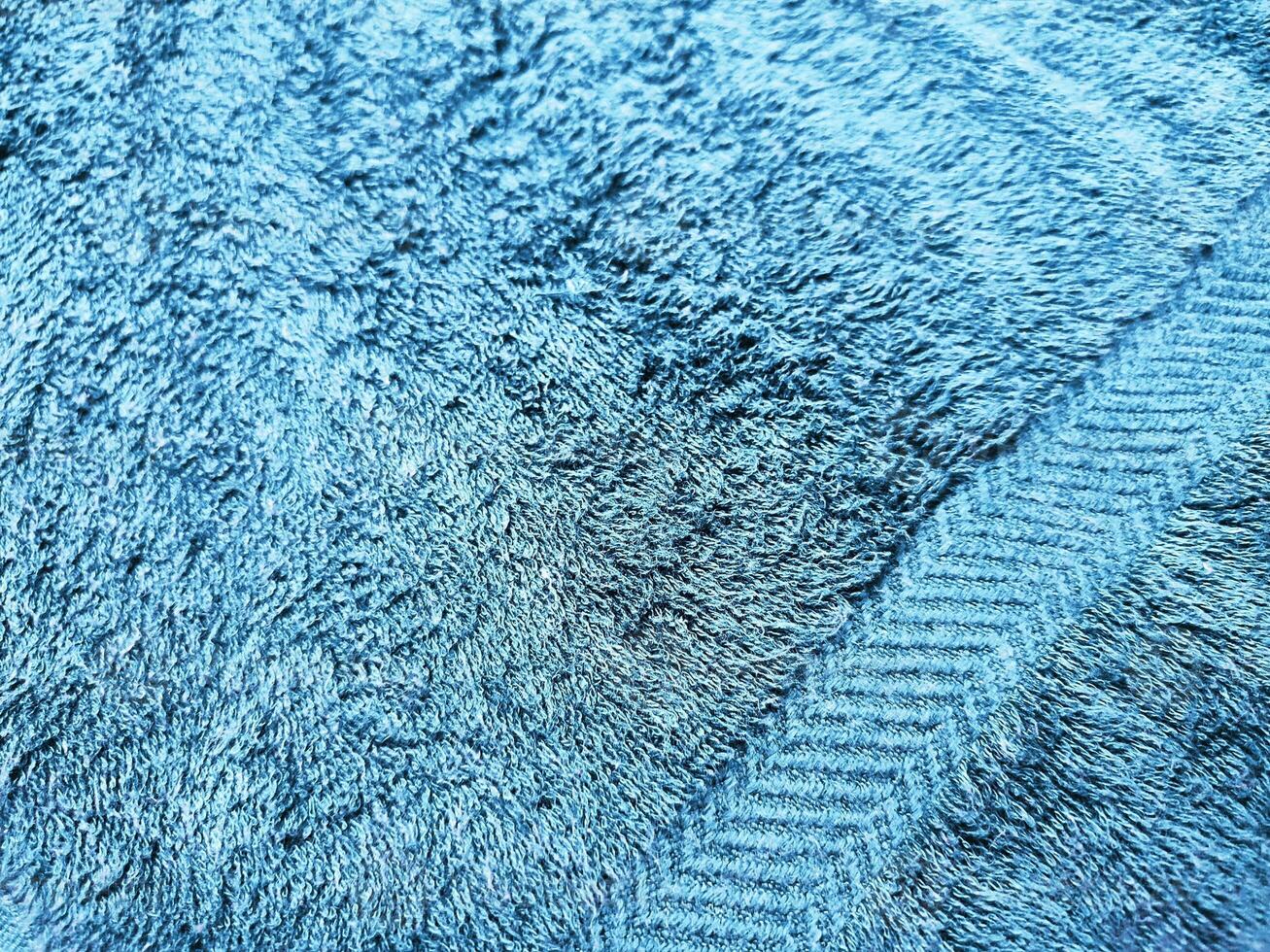 Blue background of towel texture. Beautifully folded white towels. Macro photo of beach towel. Soft textile background