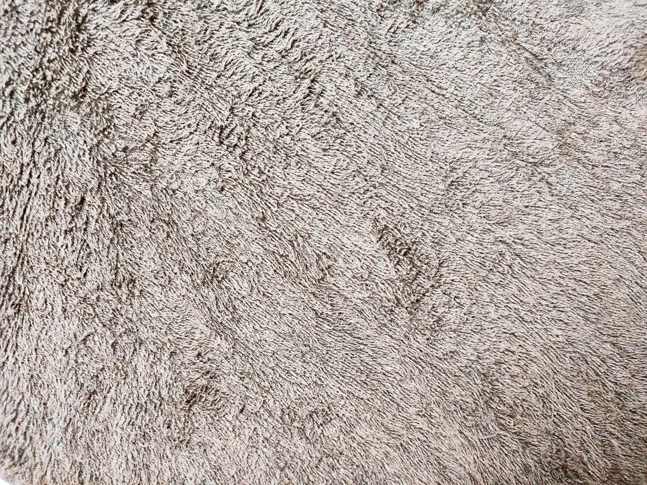 Gray brown background of towel texture. Beautifully folded white towels. Macro photo of beach towel. Soft textile background