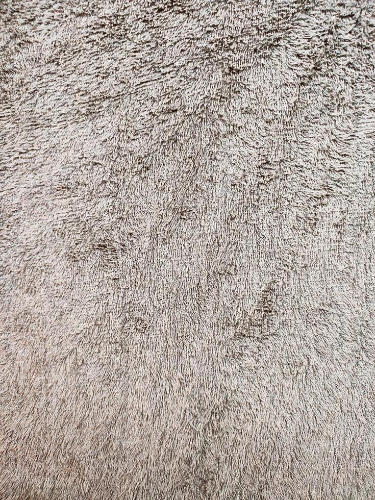Gray brown background of towel texture. Beautifully folded white towels. Macro photo of beach towel. Soft textile background