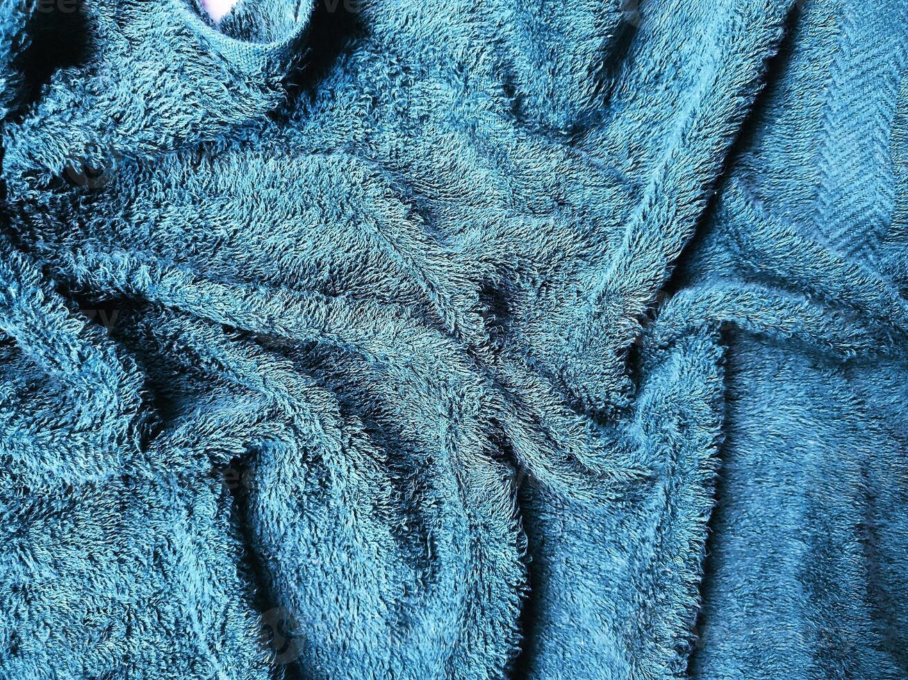 Blue background of towel texture. Beautifully folded white towels. Macro photo of beach towel. Soft textile background