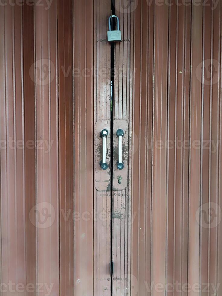 door handles and closed steel rolling shop doors photo