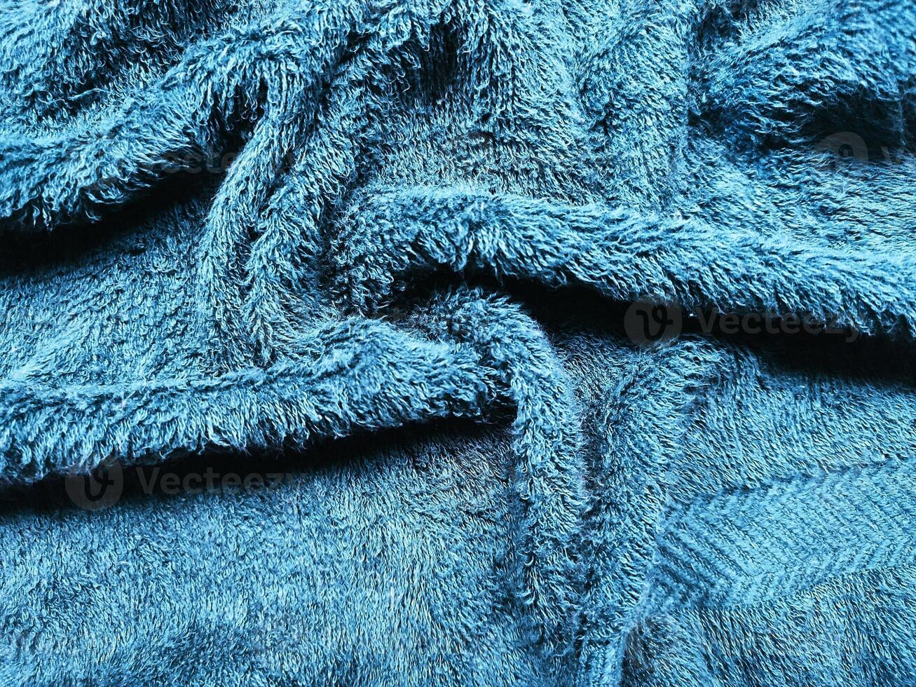 Blue background of towel texture. Beautifully folded white towels. Macro photo of beach towel. Soft textile background